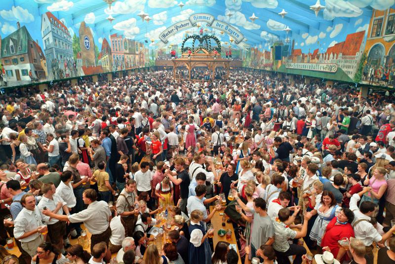 During Oktoberfest in Germany, visitors celebrate food and beverage in a vibrant atmosphere